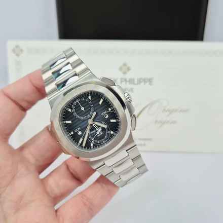  Patek Philippe Nautilus Travel Time Flyback Blue Dial 40.5mm Automático Completo 